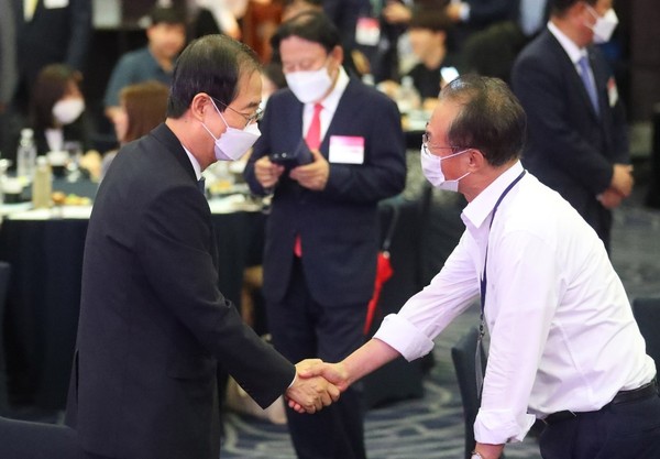 图为30日上午，在首尔中区威斯汀朝鲜酒店举行的韩中建交30周年经济论坛上，韩国务总理韩德洙和与会者握手。【照片来源：NEWSIS】
